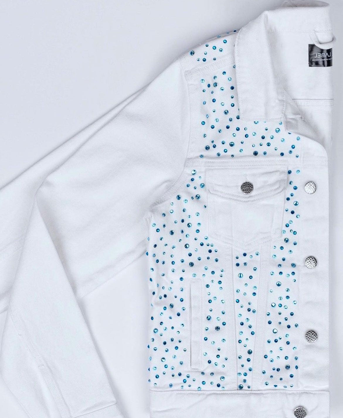 White denim jacket with blue pebbles